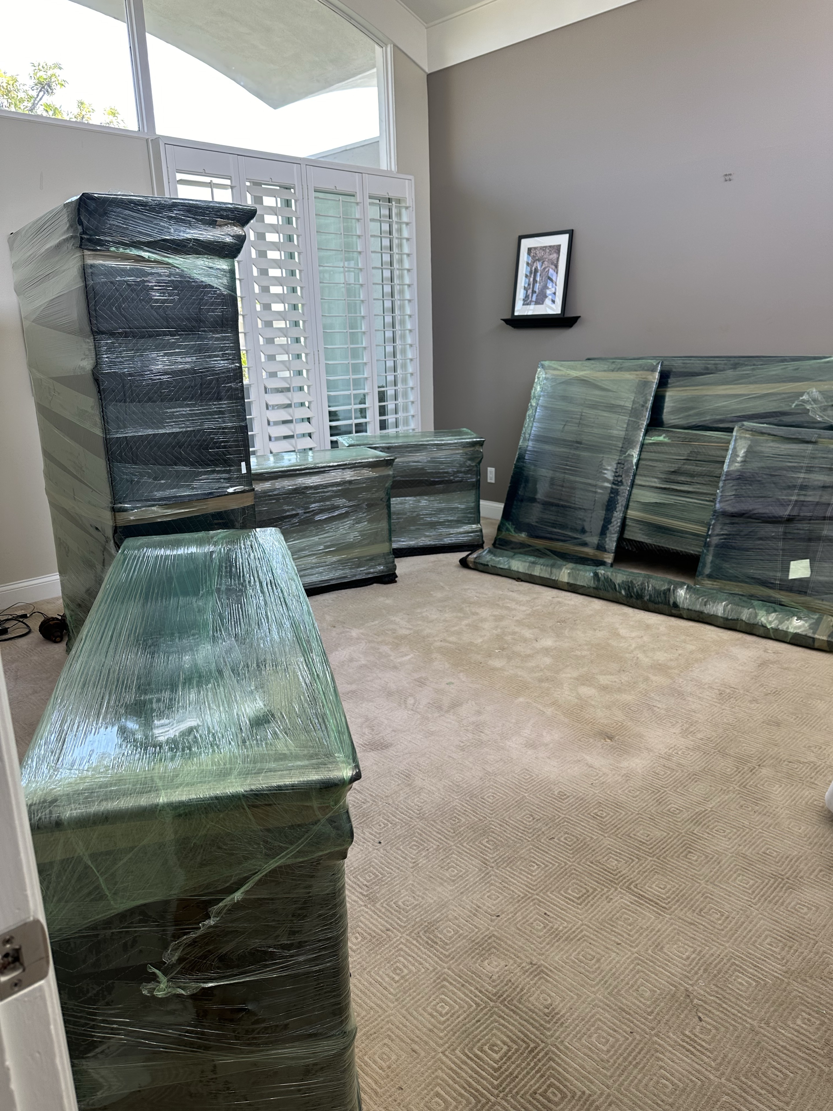 Furniture carefully wrapped with moving blankets and protective film before transport